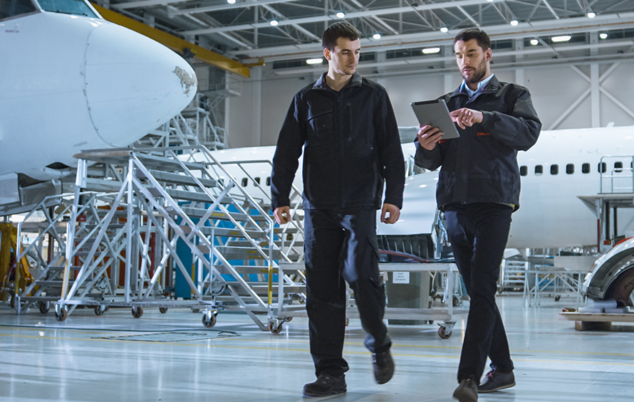 Aircraft designers working on computer based training modules on a tablet